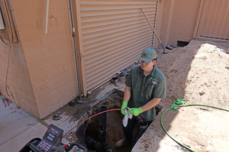 ideal services employee working on trenchless pipe replacement